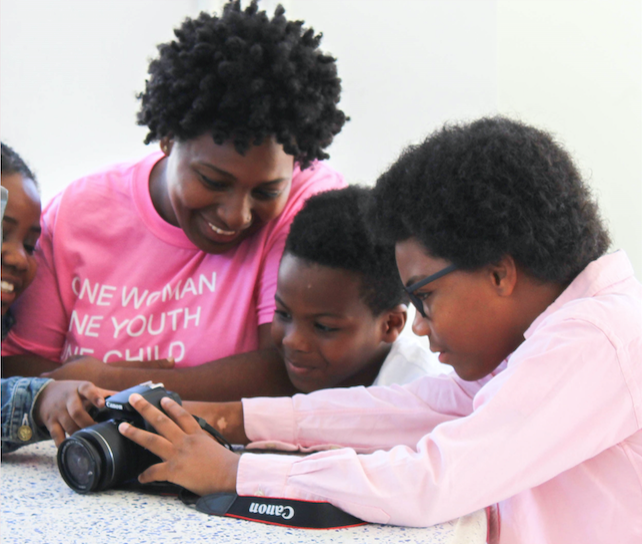 Children examine a digital camera