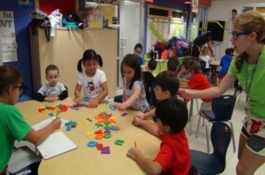 Children work with blocks at a table